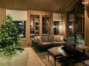 a living room with a christmas tree and a couch at Modern Cabin By Skeikampen's Ski Trails in Svingvoll +9 photos