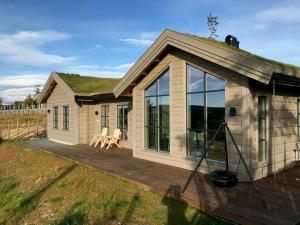 a small house with a deck with a view at Modern Cabin By Skeikampen's Ski Trails in Svingvoll
