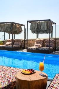 a drink sitting on a table next to a pool at Impressive One in Pyrgos
