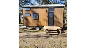 a tiny house with a table and a door at Northern Grampians Hideaway by Tiny Away in Dadswells Bridge