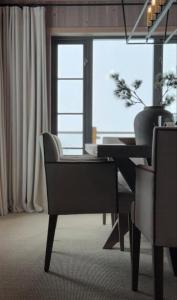 a dining room with a table and chairs and a window at Premium Cabin By Kvitfjell Ski Slopes in Ringebu