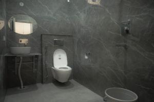 a bathroom with a toilet and a sink and a mirror at Mount Valley Mama Cottage in Rishīkesh +76 photos