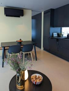 a kitchen with blue cabinets and a table with a bowl of food at Modern Cabin By Snøhetta At Blefjell in Svene