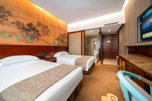 Ένα ή περισσότερα κρεβάτια σε δωμάτιο στο Eagle City Xindi Hotel +17 φωτογραφίες