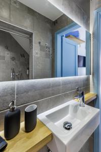a bathroom with a sink and a mirror at Le Petit Bati Blue in Skopelos Town +33 photos