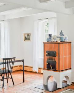 a dining room with a cabinet and a chair at Tradition Meets Modern In Gulf House in Ostermarsch