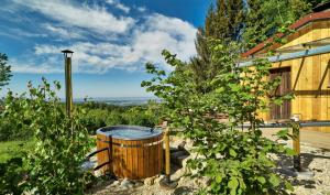 a barrel in a garden next to a house at Cabin In The Nature Of Bavaria in Schöllnach