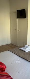 a room with a bed and a door with towels at Sea Breeze Suites in Livorno +22 photos