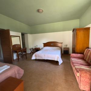a bedroom with a bed and a couch at Le Chiancate in San Giovanni Rotondo