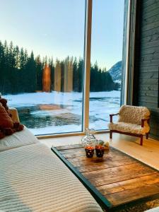 a bedroom with a bed and a chair and a window at Cabin By Heimsila River In Hemsedal in Hemsedal