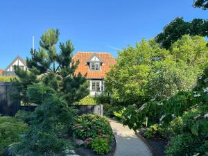 a house in the middle of a garden at Half-Timbered House With Harbor View In Ebeltoft in Ebeltoft