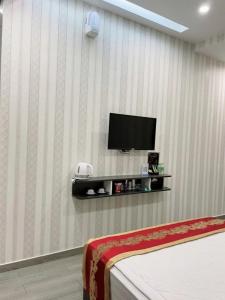 a room with a tv on a wall with a bed at TÂY NINH CITY HOTEL in Tây Ninh +27 photos