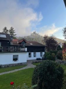 韦尼格罗德Pension Böttger的以山为背景的房子