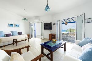 a living room with a couch and a table at Villa Drios Semeli Paros in Drios