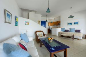 a living room with a couch and a table at Villa Drios Semeli Paros in Drios