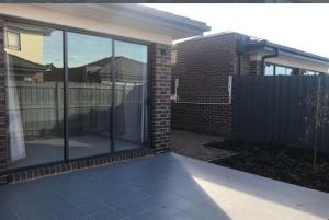 a house with glass windows and a fence at Casey Green Estate 3 bedrooms Narre Warren home in Narre Warren