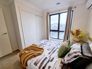 a bedroom with a bed and a large window at Casey Green Estate 3 bedrooms Narre Warren home in Narre Warren