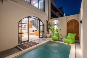 a house with a swimming pool in the yard at Villa The ARK - A by OriVista in Dalung