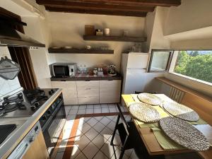 a kitchen with two tables and a stove top oven at Appartamento incantevole in Florence