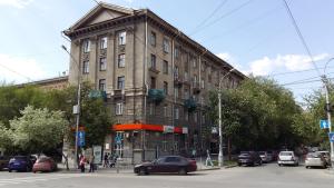 a building with a car parked in front of it at Apartment on Lenina 18 in Novosibirsk