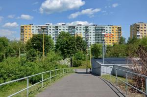 a walkway in a park with buildings in the background at Apartmán Betty in Žilina