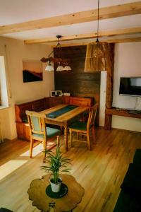 a dining room with a wooden table and chairs at Ferienwohnung Bästenbach in Bad Peterstal-Griesbach +27 photos