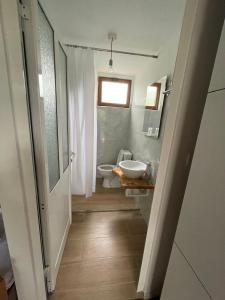 a bathroom with a toilet and a sink at SEA bed and restaurant 1 in Borsh
