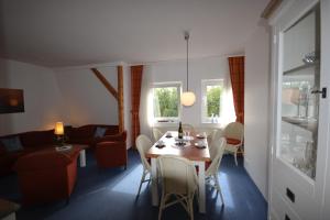 a living room with a table and a couch at Villa am Januspark in Juist
