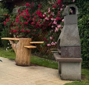 a table and a bench next to some flowers at Kleine Idylle in Luckenwalde