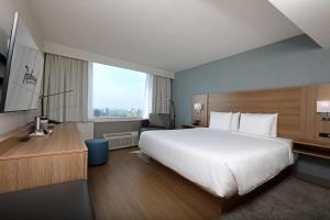 a hotel room with a large bed and a large window at Radisson Hotel Winnipeg Downtown in Winnipeg +61 photos