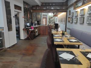 a dining room with wooden tables and chairs at Fonda Ca La Paula in Castellfollit de la Roca