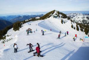 a group of people on a snow covered ski slope at Northend Tacoma Charmer in Tacoma