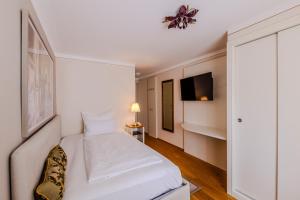 Łóżko lub łóżka w pokoju w obiekcie Boutiquehotel Amadeus