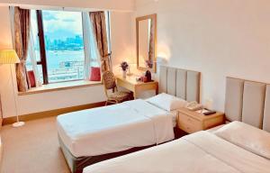 Postelja oz. postelje v sobi nastanitve Ramada Hong Kong Grand View