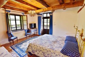 a bedroom with a bed and two chairs and a desk at Villa Bertagnolli - Locanda Del Bel Sorriso in Trento