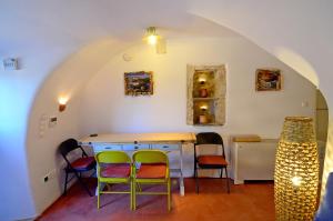 a room with chairs and a table in an archway at Rodamia Traditional Cottage in Kythira +12 photos