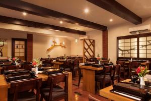 a dining room with wooden tables and chairs at Prime Plaza Hotel Purwakarta in Purwakarta +52 photos