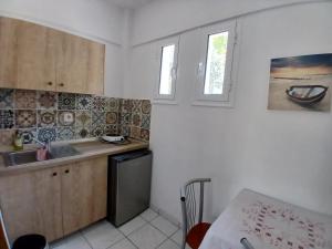 a kitchen with a sink and a counter top at Acro Studios in Skala Potamias +22 photos