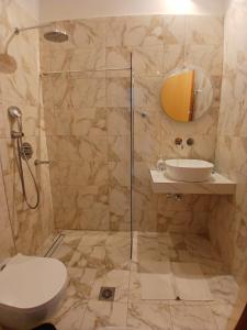 a bathroom with a shower with a toilet and a sink at Acro Studios in Skala Potamias
