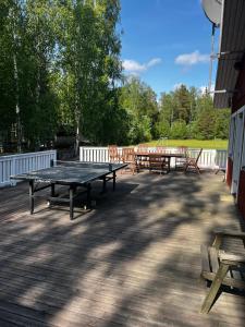 a ping pong table and benches on a deck at Country House - Kemiönsaari in Västanfjärd