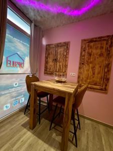 a dining room with a wooden table and chairs at Capsule Nuage Jacuzzi Sauna in Fontaine-lʼÉvêque +19 photos