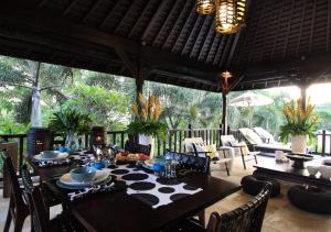 a dining room with a table and chairs at Villa Arjuna in Tanah Lot