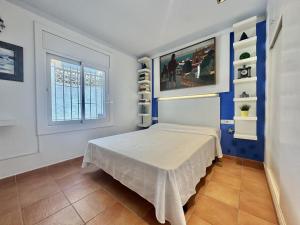 a bedroom with a bed and a window at Los Sauces in Roses +16 photos