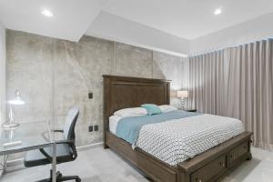 a bedroom with a bed and a desk and a chair at Ocean View - 2 King Size with Homeoffice Space in Mazatlán