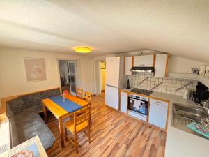 a kitchen and dining room with a table in a room at Charming Old Town Apartment in Hall in Tirol