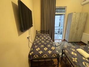a room with a bed and a tv on the wall at azahostel in K'obulet'i