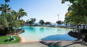 a large swimming pool in a resort at Redcliffe Beachside Escape in Redcliffe