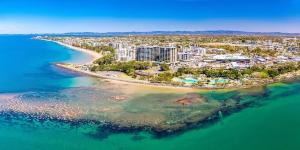 an aerial view of a beach and the ocean at Redcliffe Beachside Escape in Redcliffe