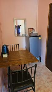 a dining room with a table and a mirror at วรรณรีสอร์ทwanresort in Seka