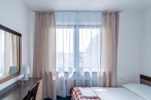 Postel nebo postele na pokoji v ubytování Pensjonat Pod Lwem